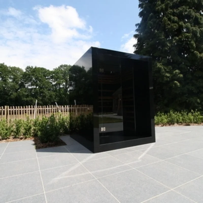 Luxury cube-shaped design outdoor sauna with infrared, glass front and modern aluminium finish, in the garden for the ultimate outdoor wellness experience.